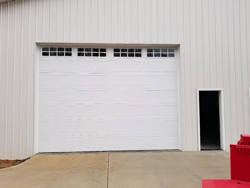 White commercial garage door on metal building